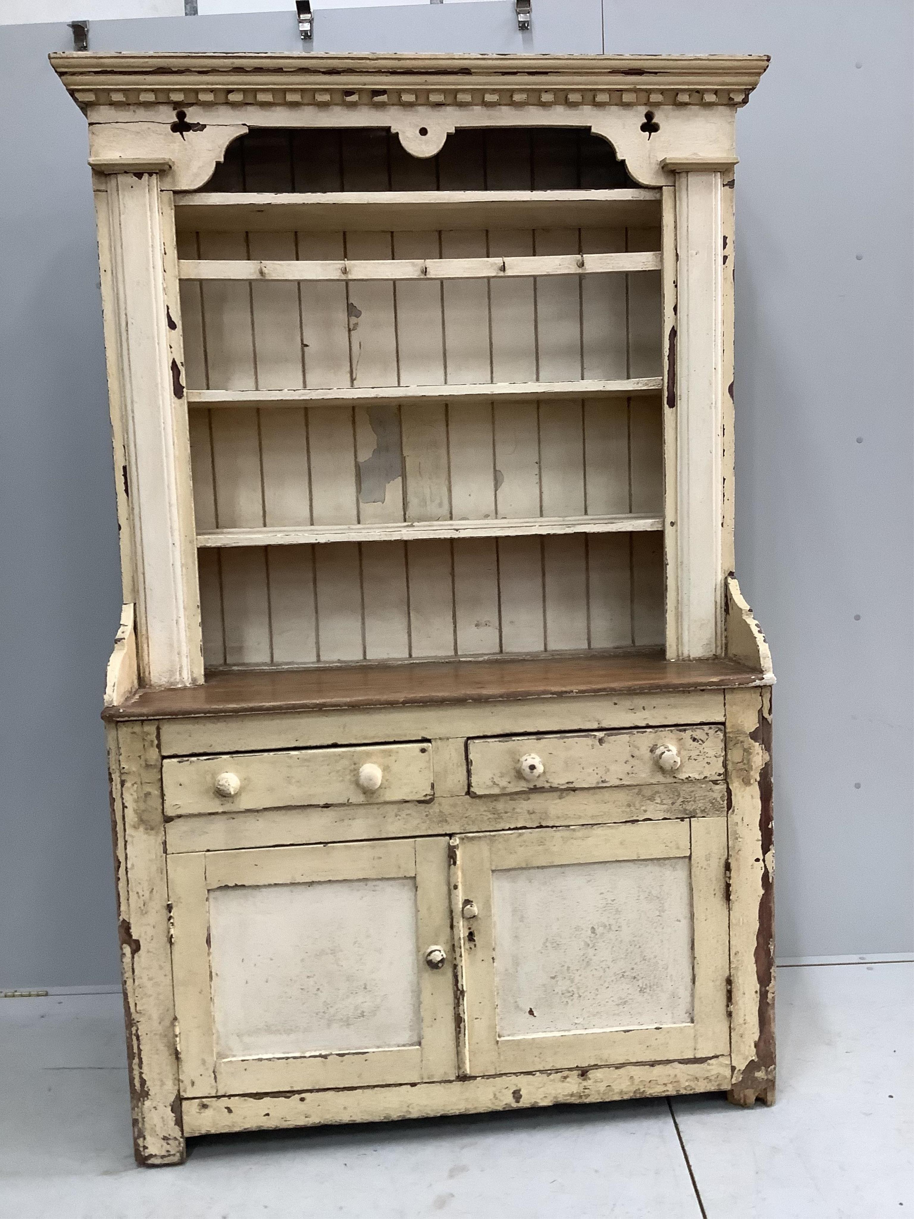 An early 19th century Irish painted pine dresser with boarded rack, width 126cm, depth 49cm, height 210cm. Condition - fair